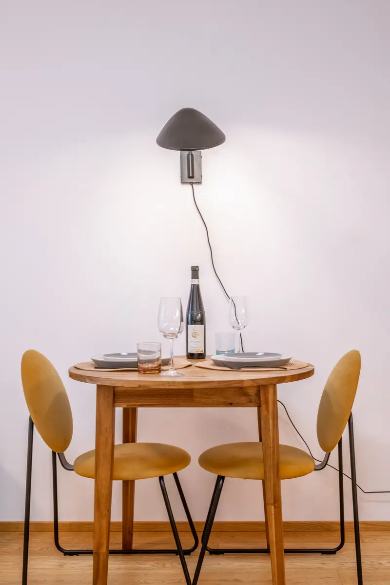 Intimate dining table for two with wine and mushroom wall lamp