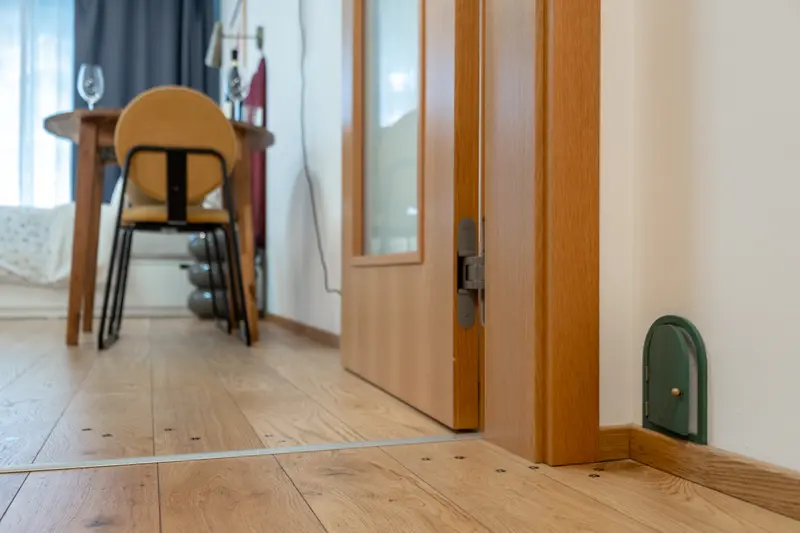 Charming miniature fairy door detail near the floor