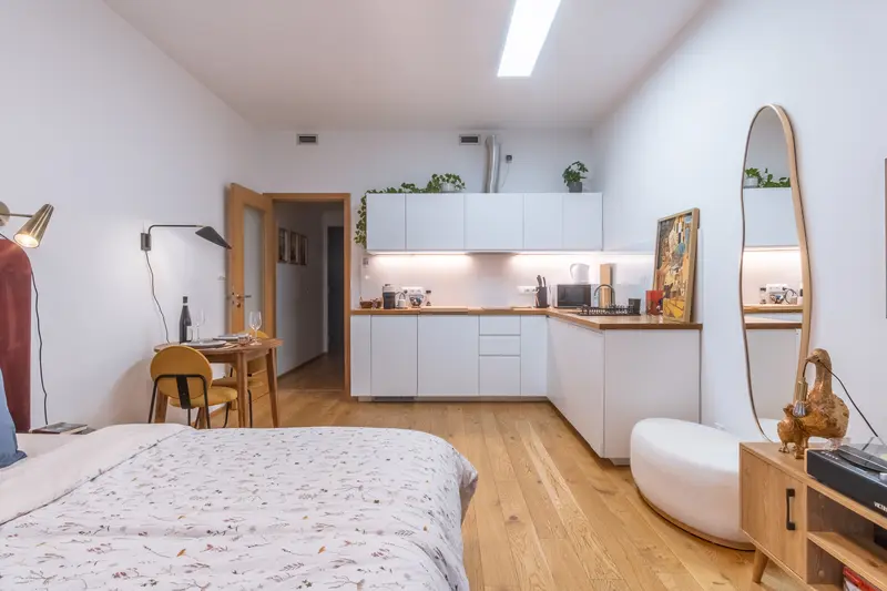Open-plan studio with kitchen, dining area and king bed