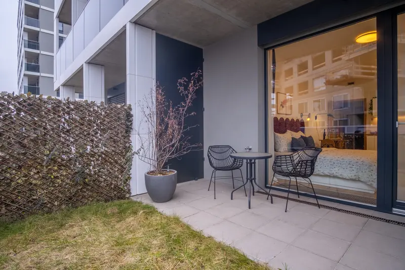 Private terrace with garden seating and floor-to-ceiling glass doors